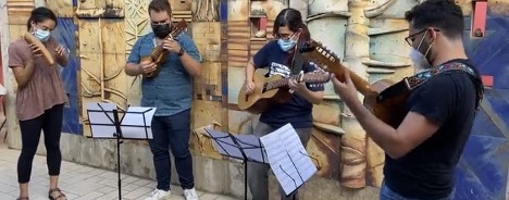 A quartet of musicians perform outside