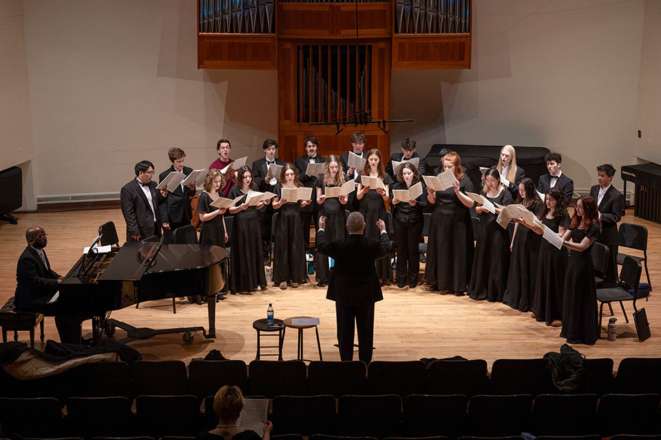 The Brandeis Chamber Singers performing on stage.