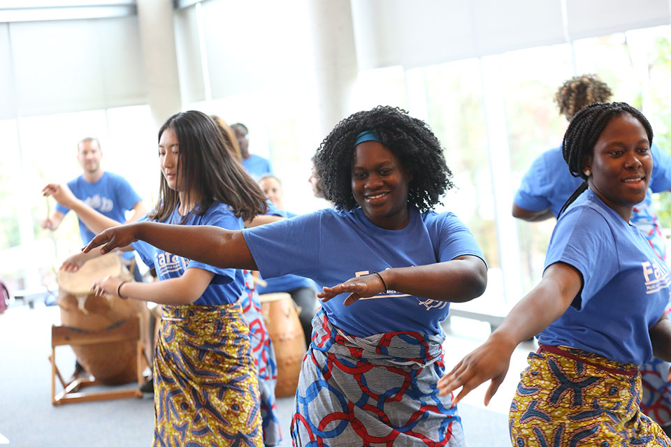 Fafali members dance together.