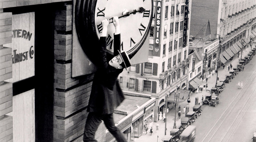 A film still featuring Harold Lloyd hanging from a clock tower