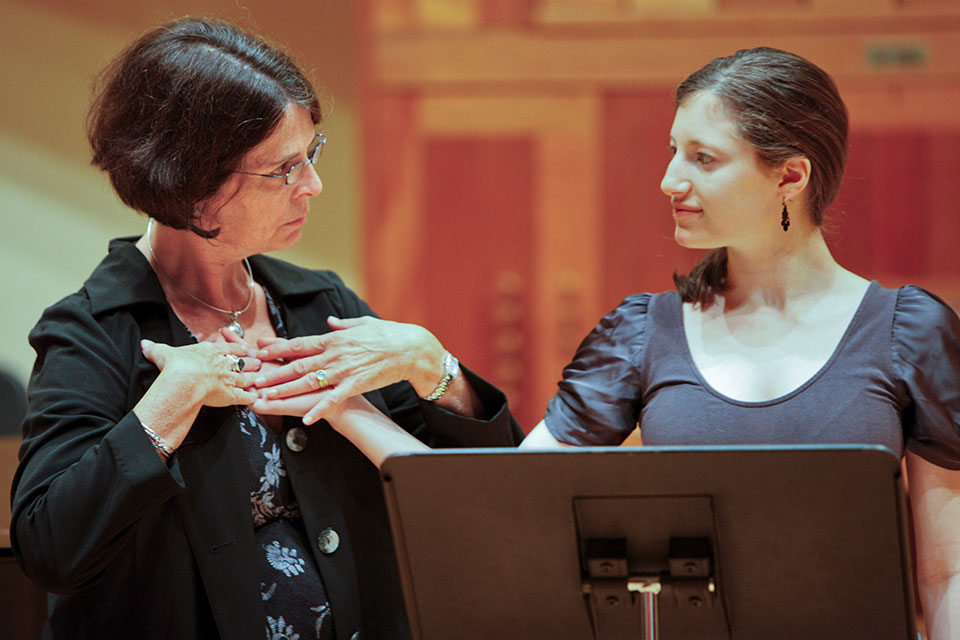 A vocal instructor works with a student