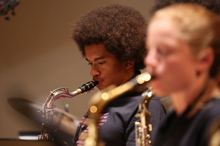 A member of the Brandeis Jazz ensemble plays the saxophone