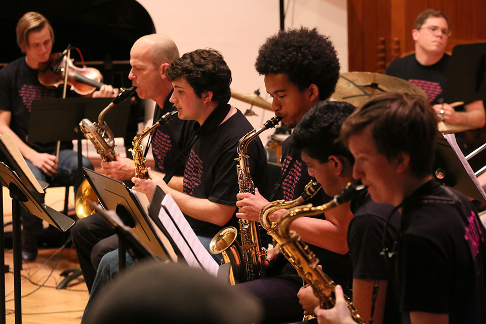 Members of the Brandeis Jazz Ensemble perform on stage.