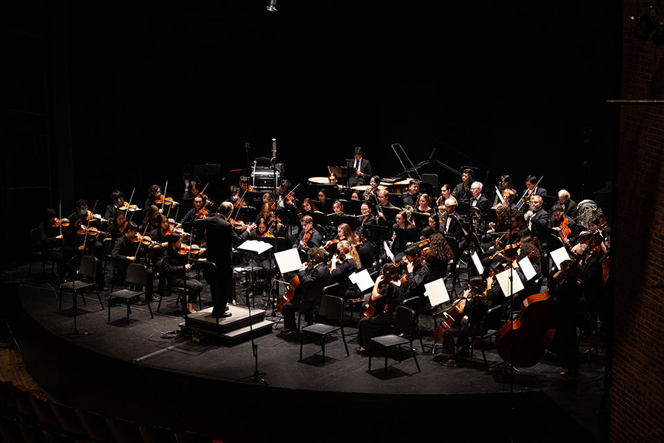 The Brandeis-Wellesley Orchestra playing on stage
