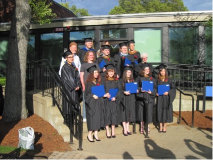 2014 graduates and faculty in cap and gowns with diplomas