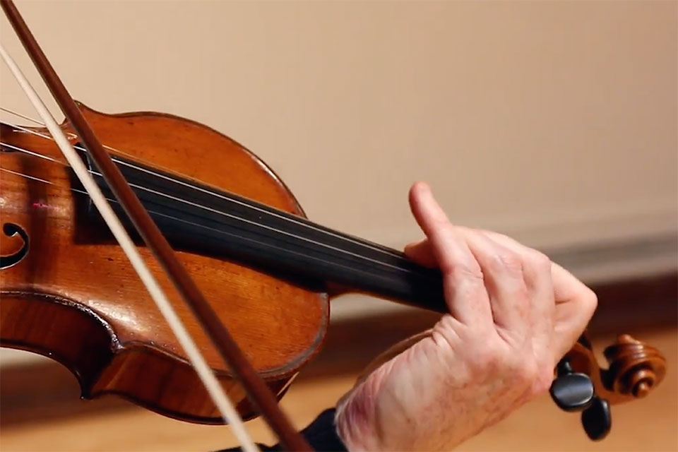 Close up of someone playing the violin