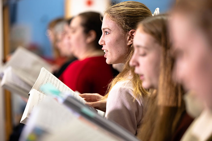A group of students sing together