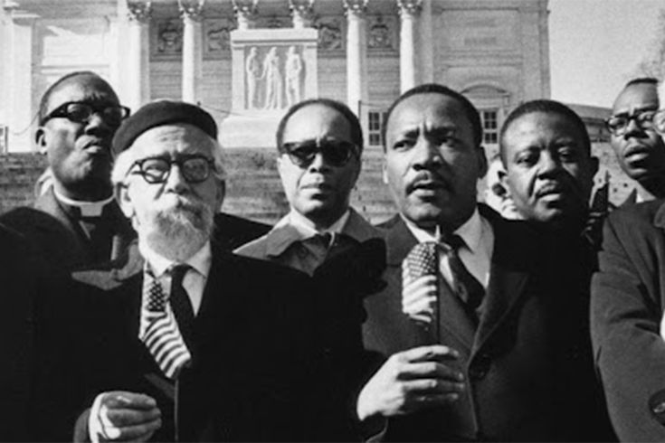 Black and white photo of Abraham Heschel and Martin Luther King Jr. and others.