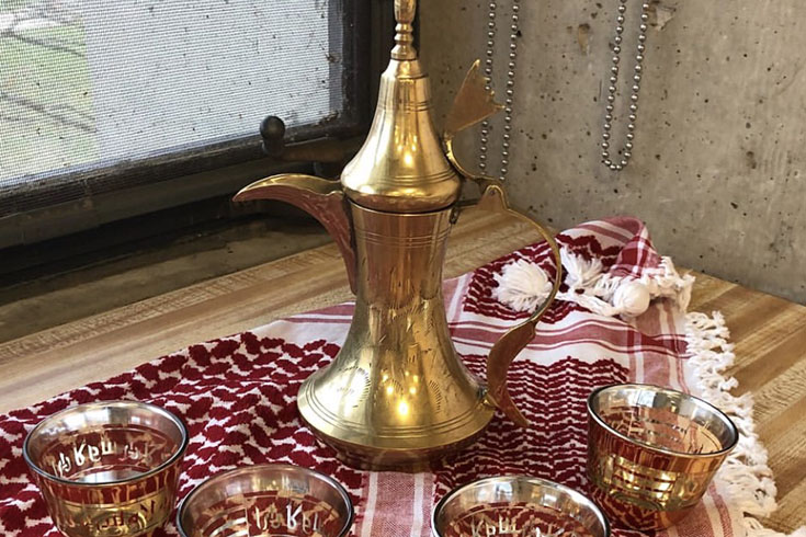 Arabic coffee pot with 4 golden coffee cups decorated with "Ahlan wa sahlan" Arabic calligraphy