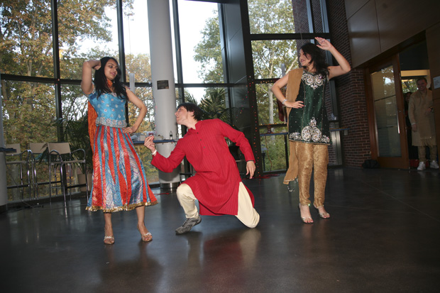 Students in colorful clothing prepare to perform for the South Asian festival Diwali