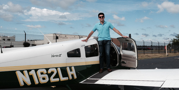 Matthew Kriegsman '11 posing with his plane.