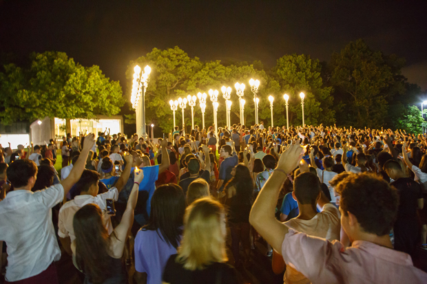 Brandeis students gather beneath light of reason sculpture 