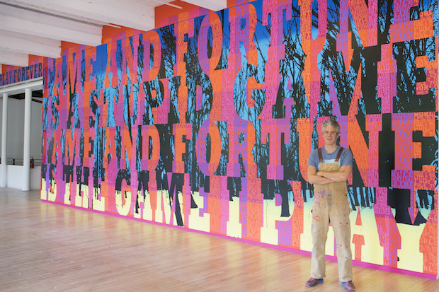 Joe Wardwell in front of his 144 foot long mural at MASS MoCA.