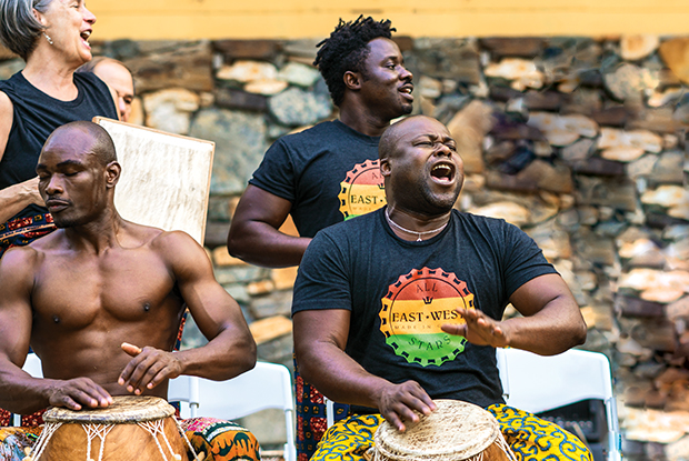 Drummers play Ghanaian drums.