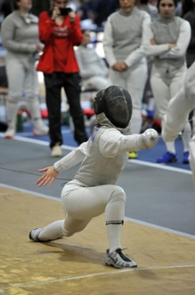 Joanne Carminucci lunges at her opponent on a fencing strip