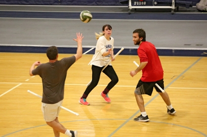 The Brandeis Quidditch team practices in Gosman. Players hold sticks for brooms 