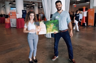 Julie Dai, left and Wasseem Ghrayeb, both 2019 Our Generation Speaks Fellows, hold a sign for LipifAI, their venture, at MassChallenge in Boston