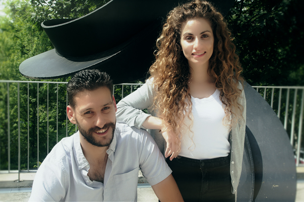 Waseem Ghrayeb, left, and Julie Dai, both Our Generation Speaks 2019 fellows, in front of a black steel sculpture