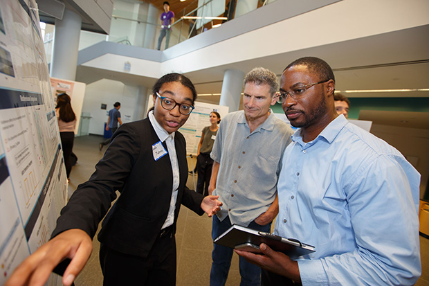 Student points to poster at SciFest 2019