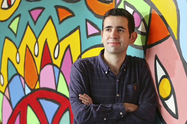 Santiago Montoya posing in front of a colorful mural