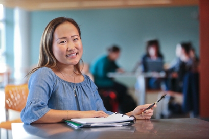 Yvette Cho '19 with a notebook and pen