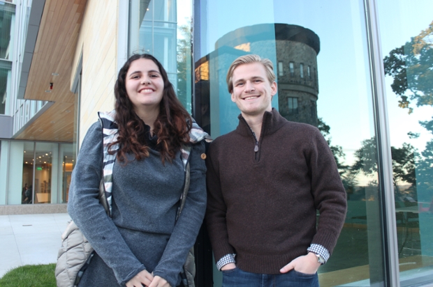 Emma Ghalili ‘22 Roman Loper ‘20, standing in front of a window at Skyline with reflections