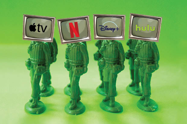 four toy soldiers wearing television screens bearing logos of streaming services