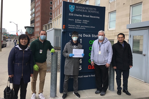 Jane Meng, P '22, left, Kayson Ding '21, center, and Thomas Chen P '24, right, personally delivered 30,000 face masks to MGH on April 1.