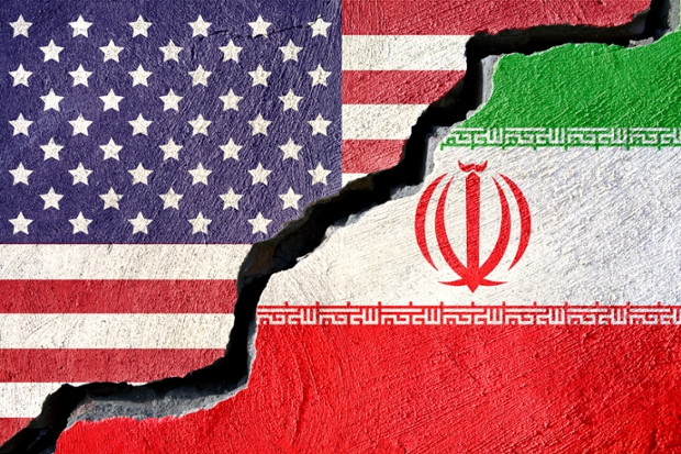 an image of U.S. and Iraqi flags painted on concrete with a large diagonal crack separating the two