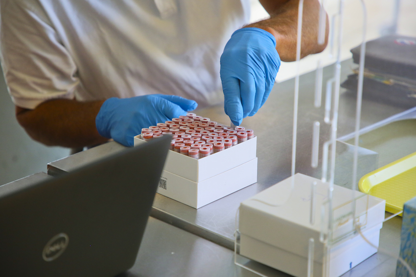 A person puts sample tubes into a box