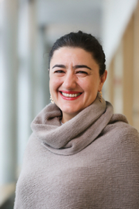 Head shot of  Professor Naghmeh Sohrabi in a cowl-neck sweater