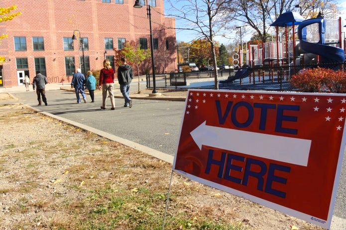 Sign that says vote here outside polling place