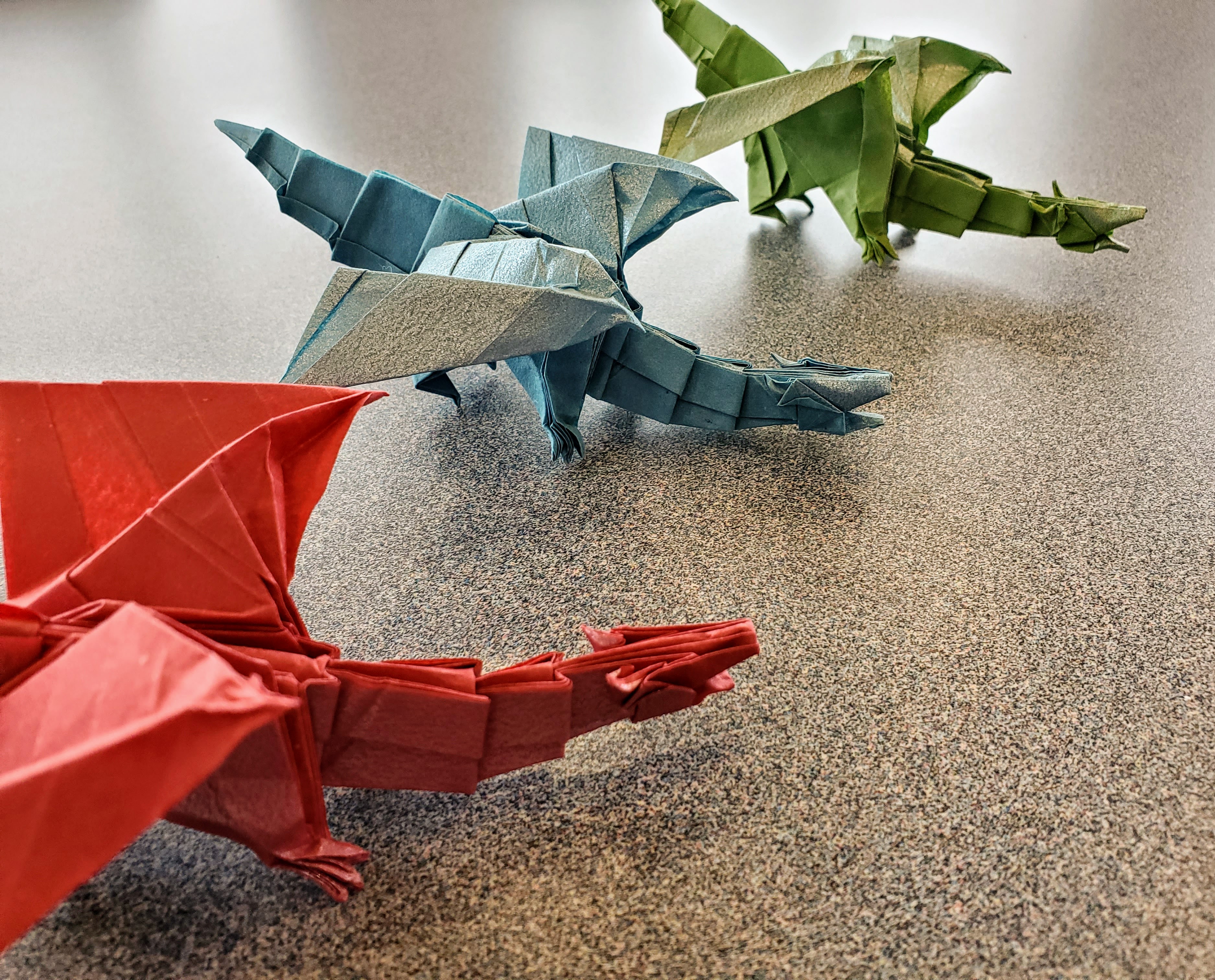 Three colorful oragami dragons