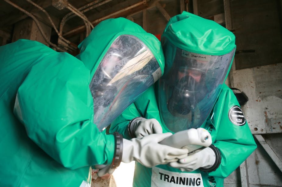 Nuclear defense specialists inspect the chemicals they found during the first field exercise.