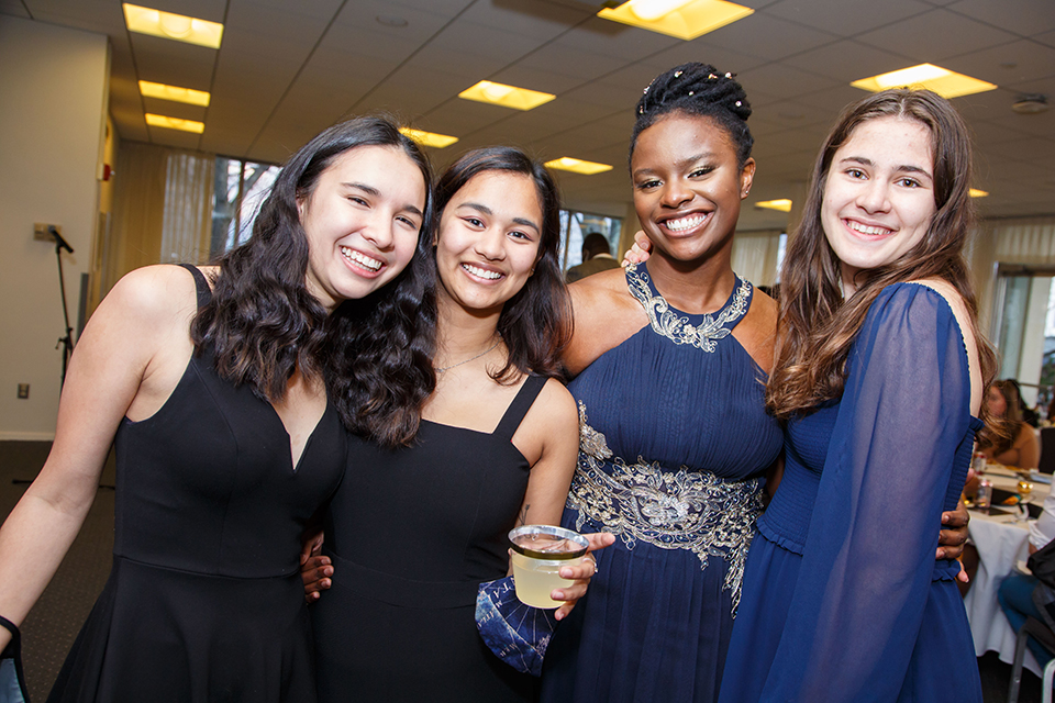 Four students pose for a photo at the State of Blackness event