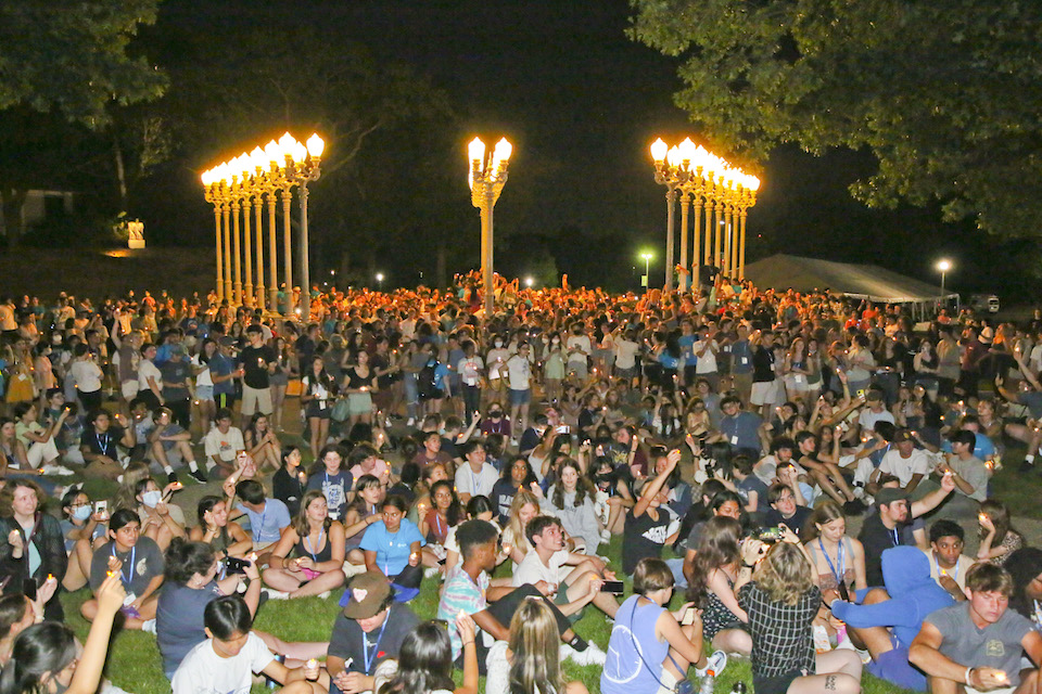 Throngs of students at the light of reason art installation at night