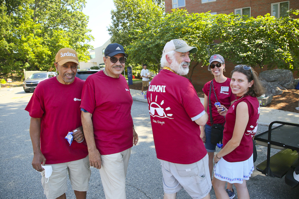 5 alumni pose for the camera. They came to campus to help with move-in