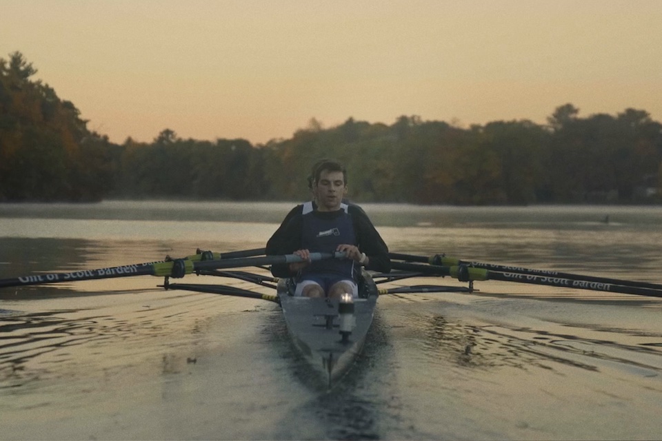 Rowing team rows up the Charles River at sunrise