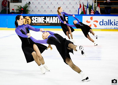 Evan Israel holds the figure skater in a pose