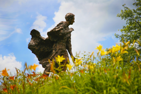 Louis Brandeis statue in summer with flowers in foreground