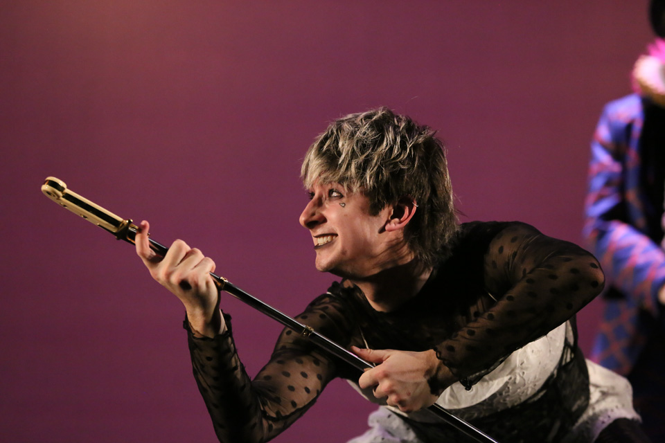 Expressive student holds sword 