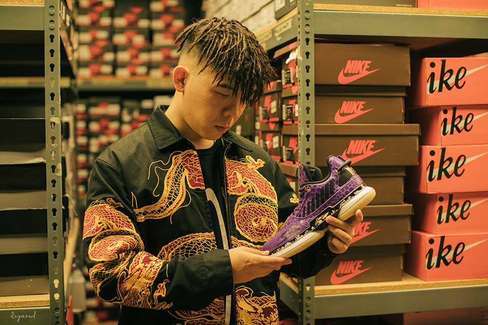 Green Xia looks at a sneaker 