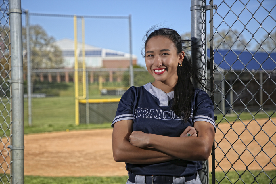 Jolie Fujita poses in front of the softball field