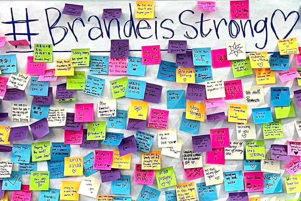 The hashtag Brandeis Strong with a heart is written at the top of a large poster-sized paper. There are many colorful post-it notes stuck on the paper with supportive messages from community members.