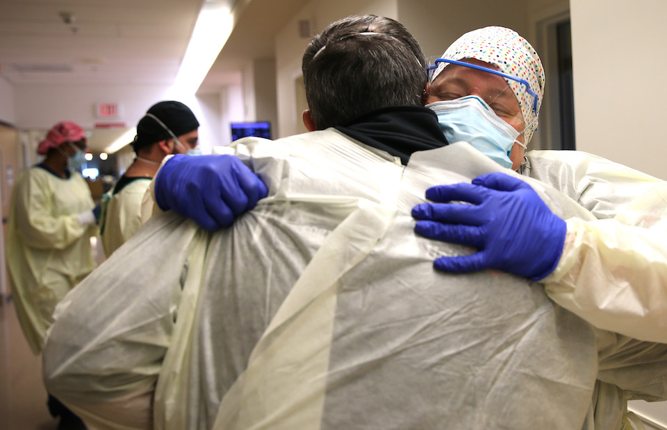 Chaplain Kevin Deegan hugs registered nurse Connie Carrillo