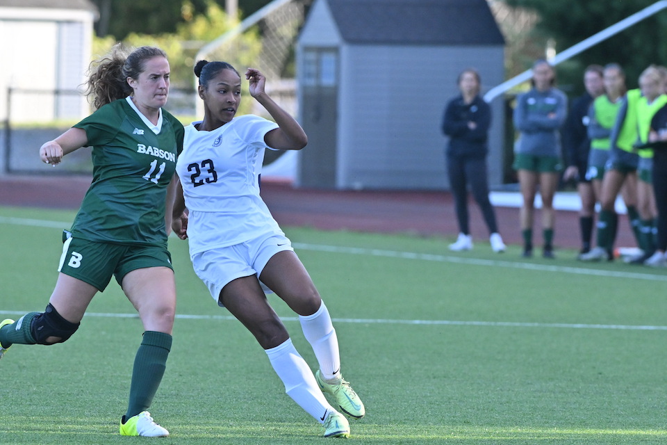 Soccer player Morgan Clark competes with a player from Babson in a match