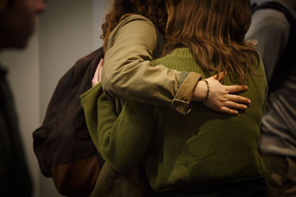 Two students embrace during Vanessa Mark memorial