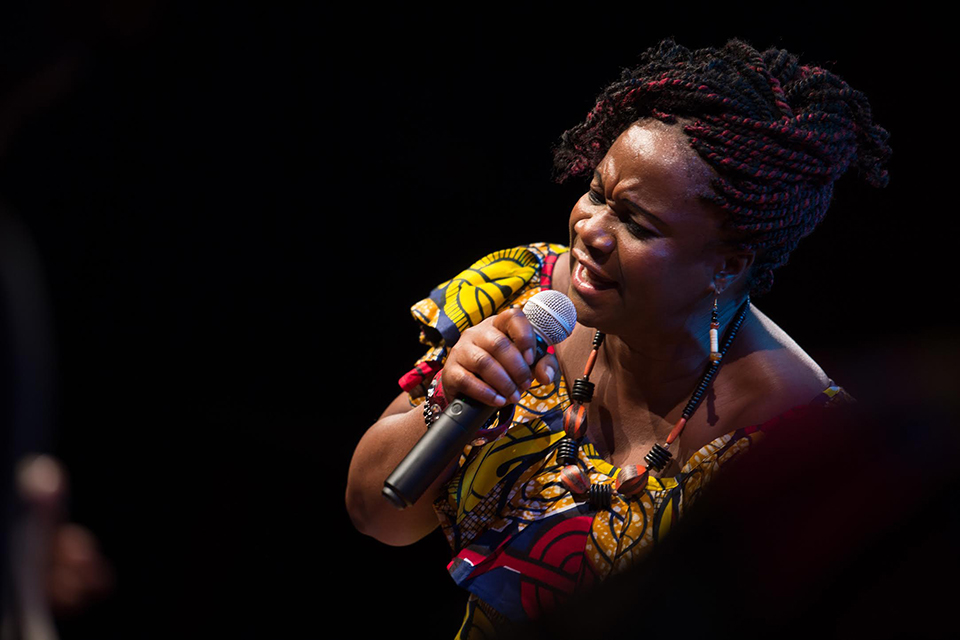 Fatu Gayflor, artistic director of the Liberian Women's Chorus for Change, and one of the women who tells her story in the movie, Because of the War, here shown performing on stage