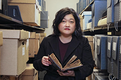 Dorothy Kim in library holding books