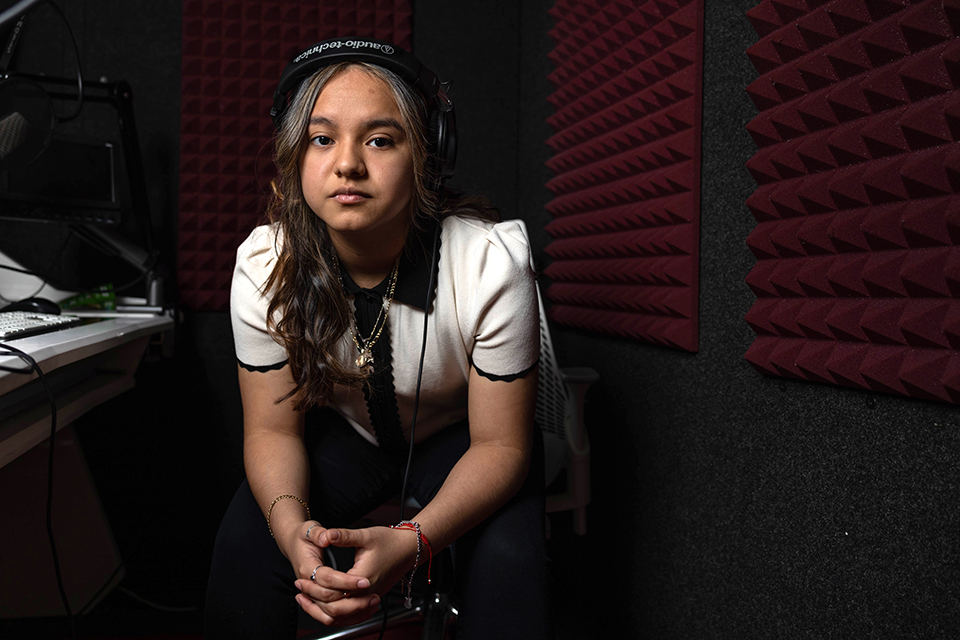 Liz Sandoval sits in the recording studio